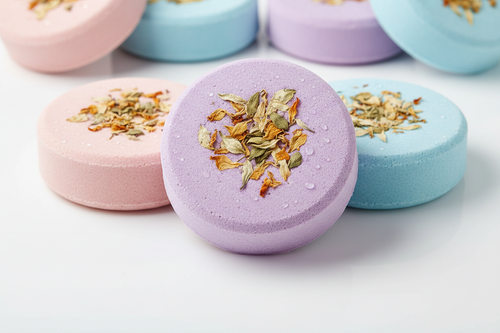 hockey puck style bath bombs with flower petals in them